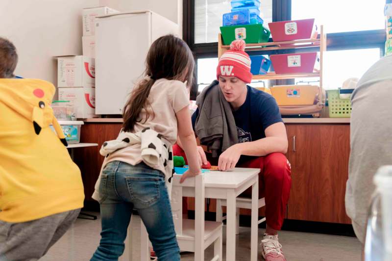 a man and girl playing with toys