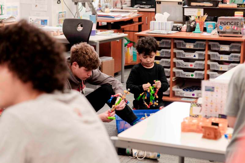 a group of kids playing with toys in a classroom