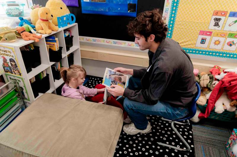 a man and a girl reading a book