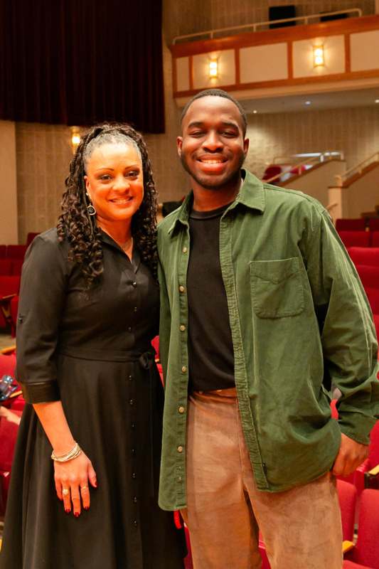 a man and woman standing together in a theater