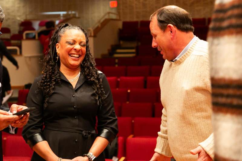 a man and woman laughing in a theater