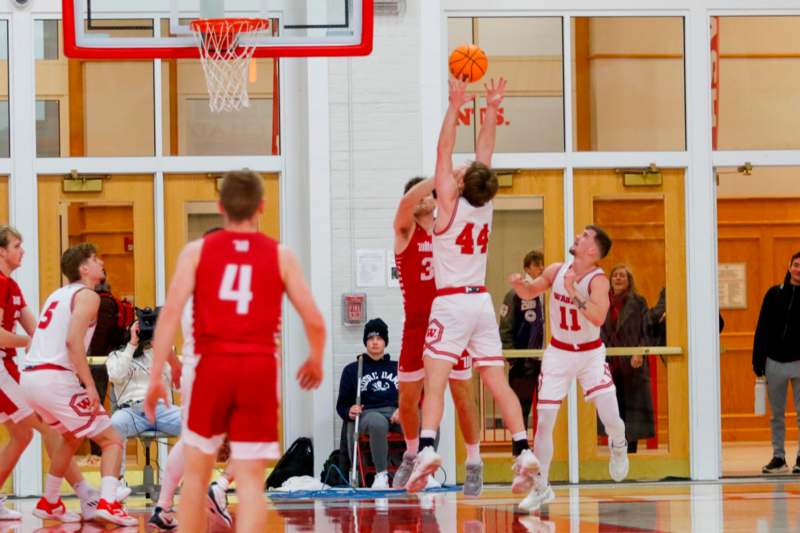 a group of men playing basketball