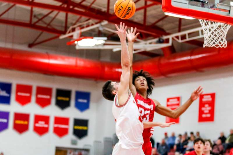 a basketball player jumping to block a basketball