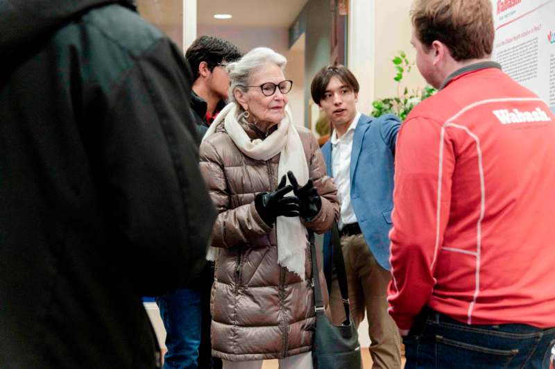 a group of people standing around a woman