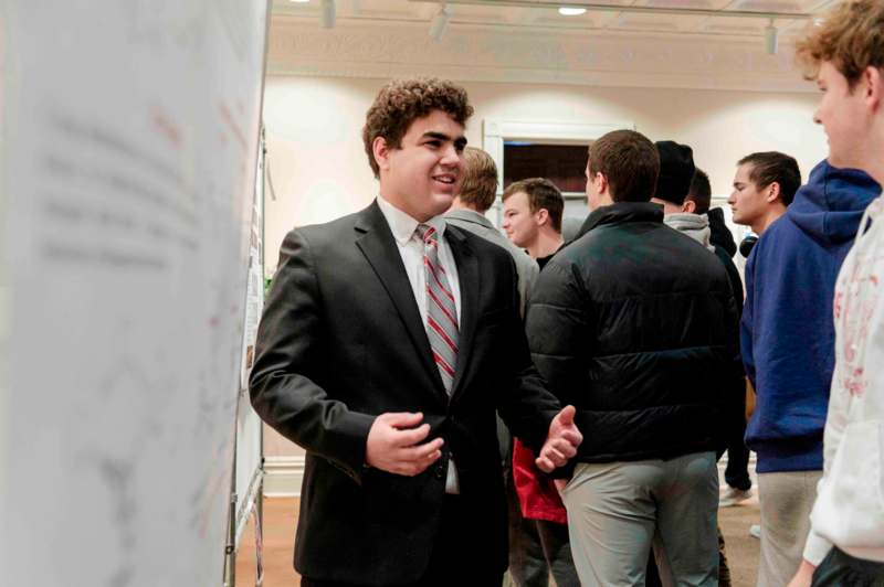 a man in a suit and tie shaking hands