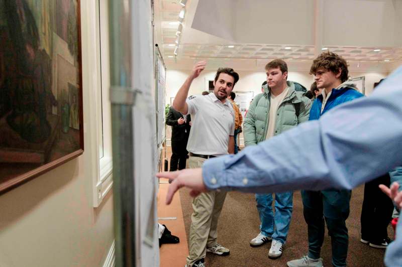 a man pointing at a poster