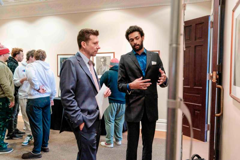 a group of men in suits talking