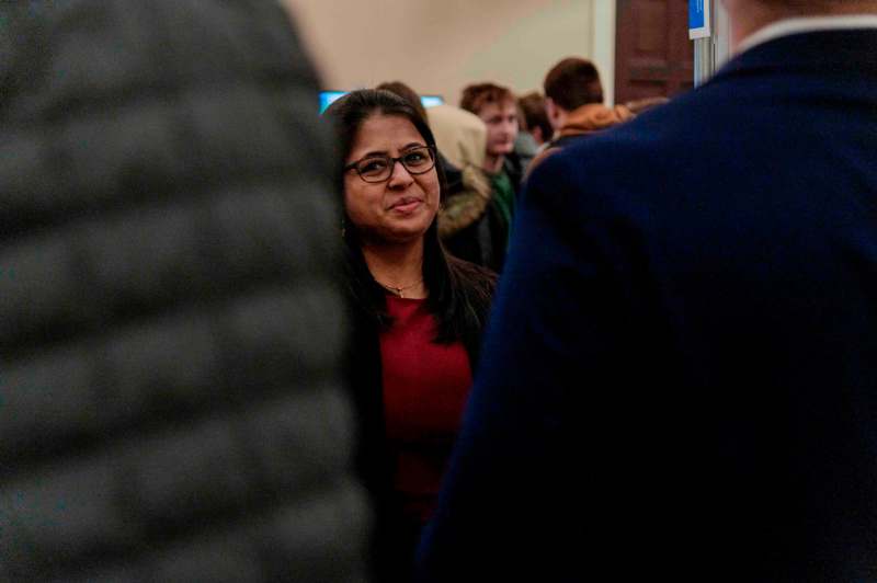 a woman in glasses standing in a crowd