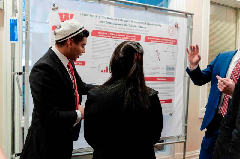 a man and woman looking at a poster