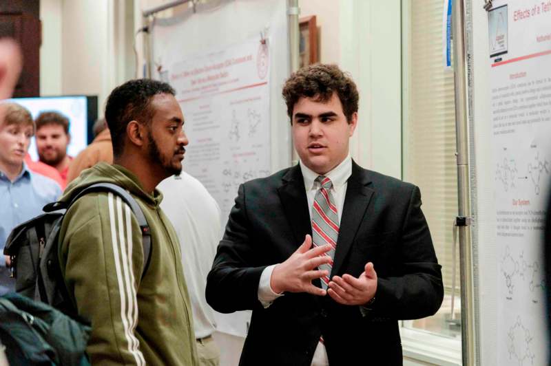 a man in a suit talking to another man