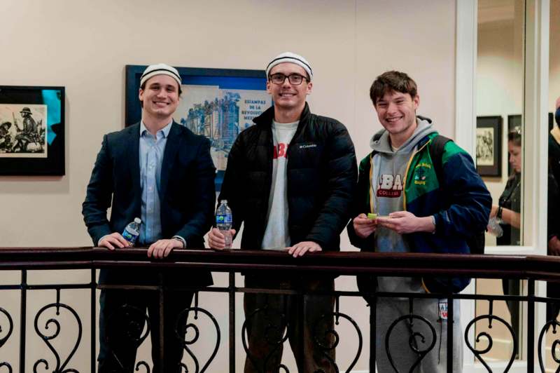 a group of men standing next to a railing