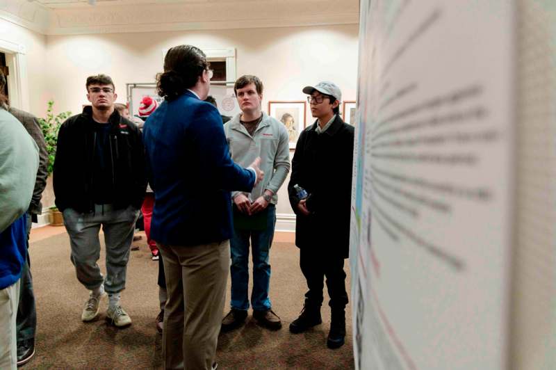 a group of people standing around a poster