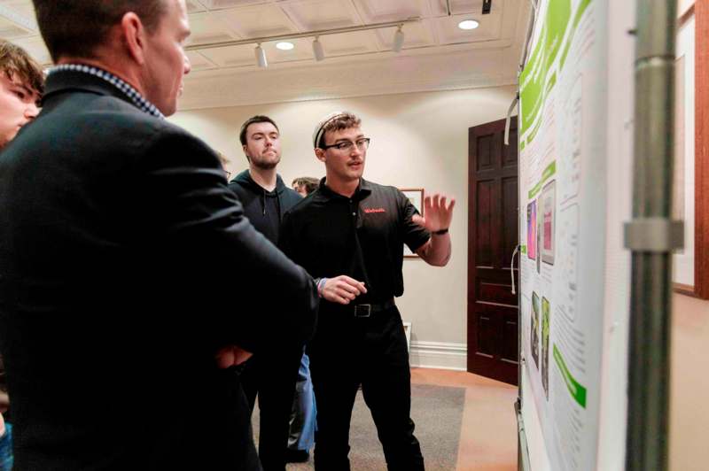 a group of men looking at a poster