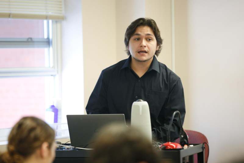 a man standing in front of a laptop