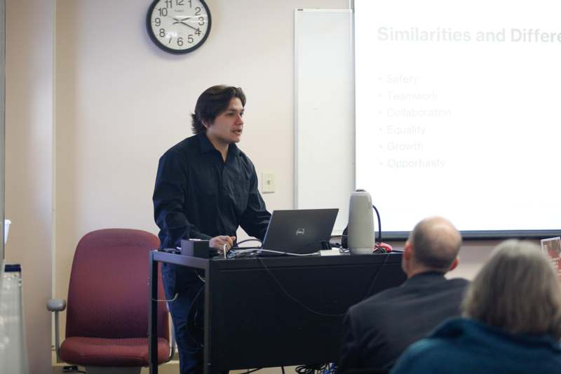 a man standing in front of a laptop