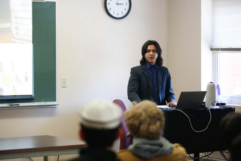 a man standing in front of a laptop