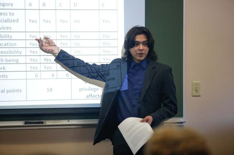 a man standing in front of a projection screen