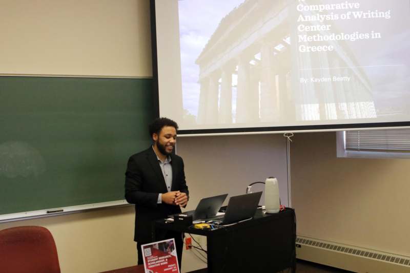 a man standing in front of a screen