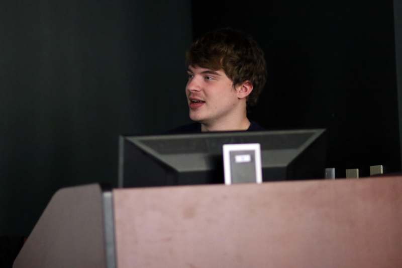 a man standing behind a podium