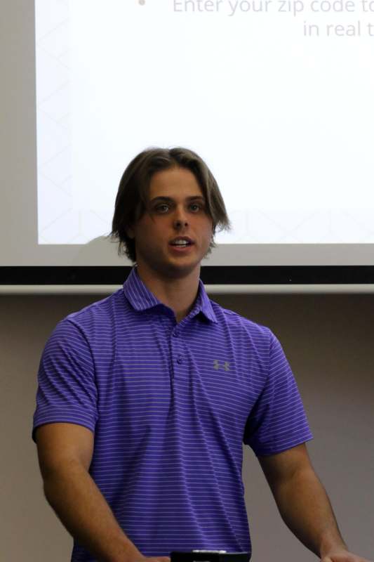 a man in a purple shirt