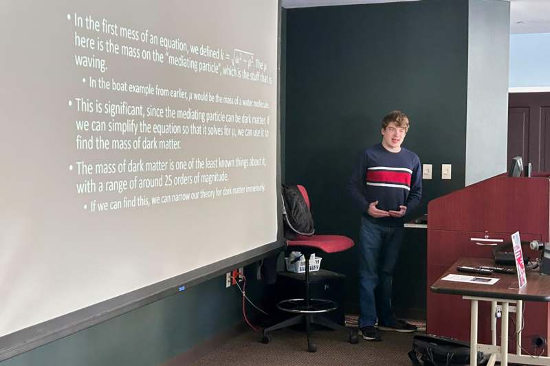 a man standing in front of a projection screen