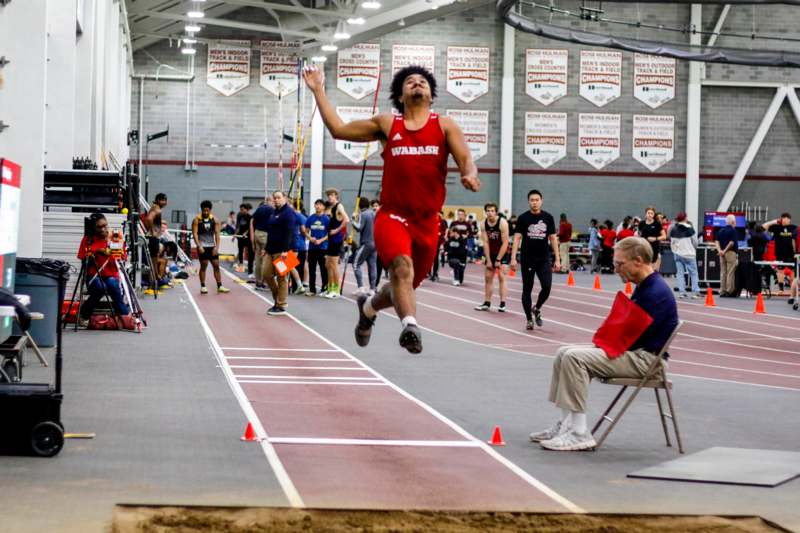 a man jumping in the air on a track