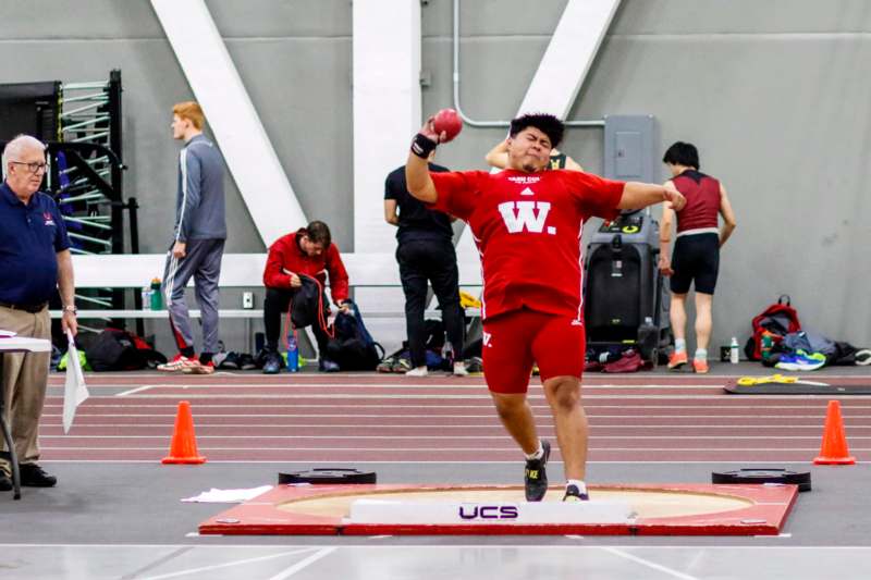 a man throwing a ball in a track