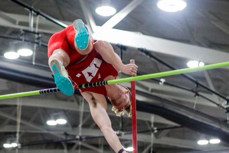 a man jumping over a bar