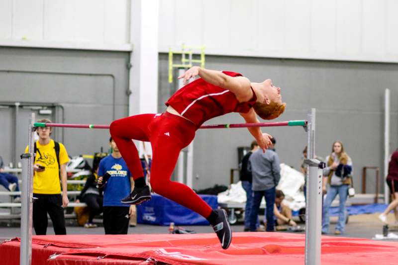 a man jumping over a bar