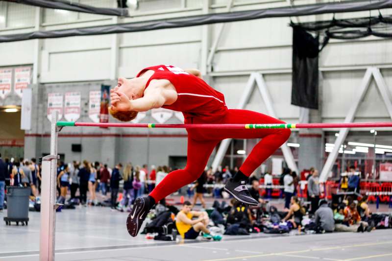 a man jumping over a bar