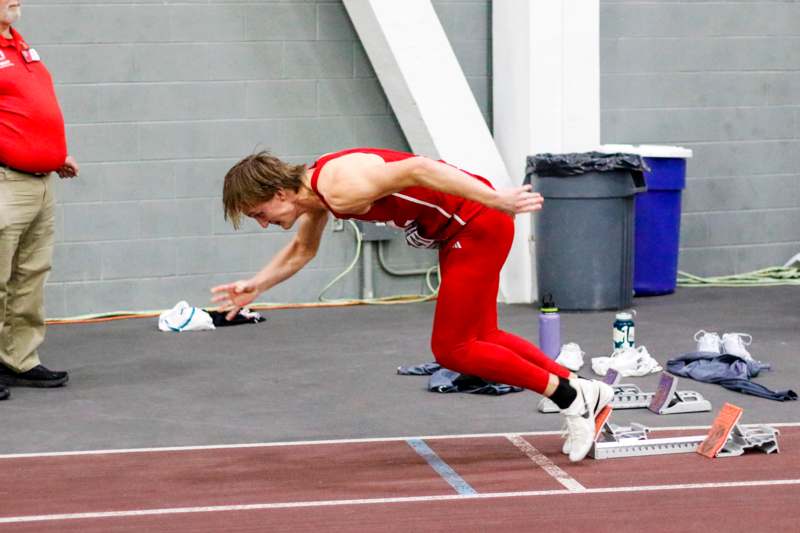 a man in red running on a track