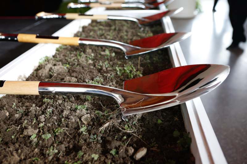 a row of shovels in a planter