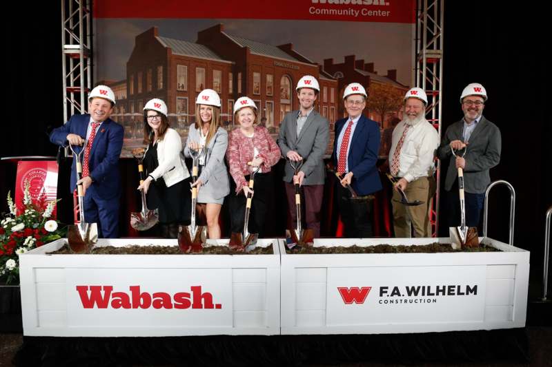 a group of people wearing white helmets and shovels