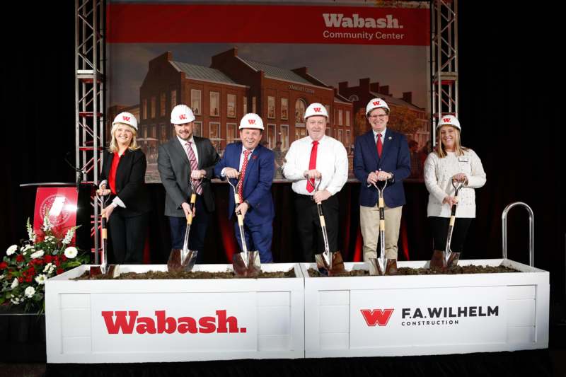 a group of people wearing helmets and shovels