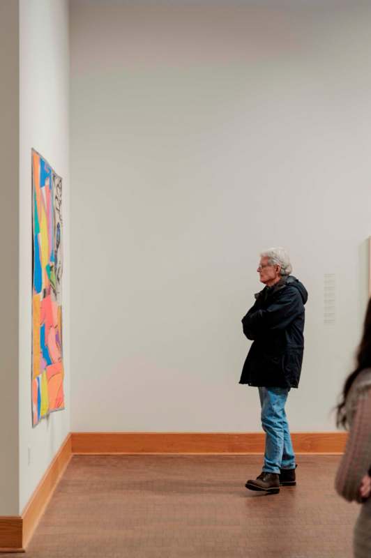 a man looking at a piece of art