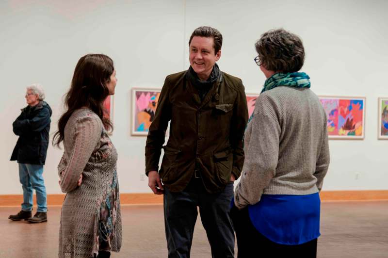 a man standing in front of a group of women