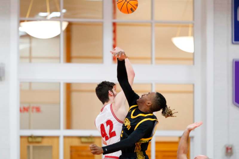 a group of men playing basketball