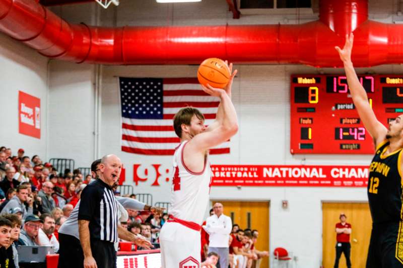 a man in a basketball uniform with a ball in his hand