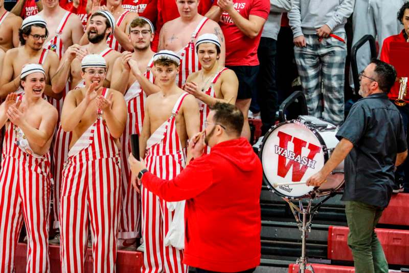 a group of men in red and white striped overalls