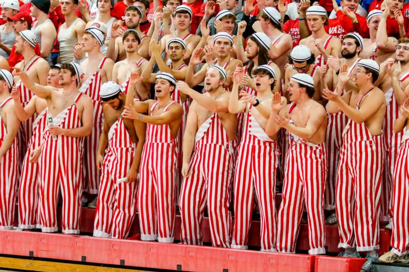 a group of people wearing striped overalls