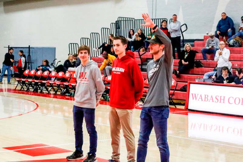 a group of people standing in a gym