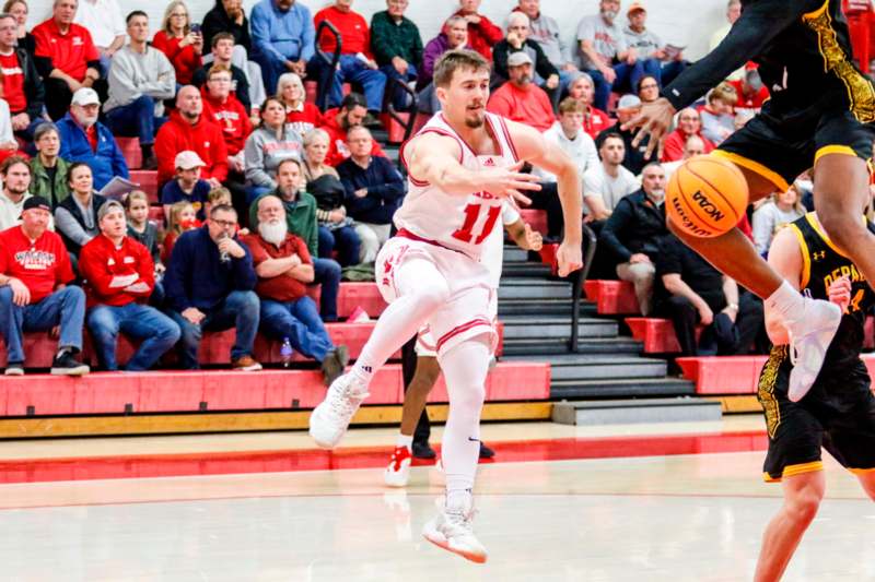 a basketball player dribbling a basketball