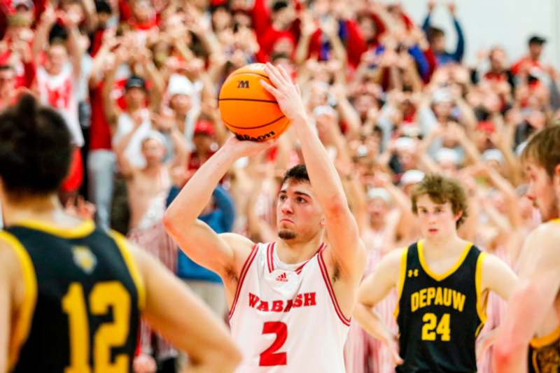 a basketball player in a uniform with a ball in his hand