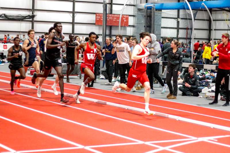 a group of people running on a track