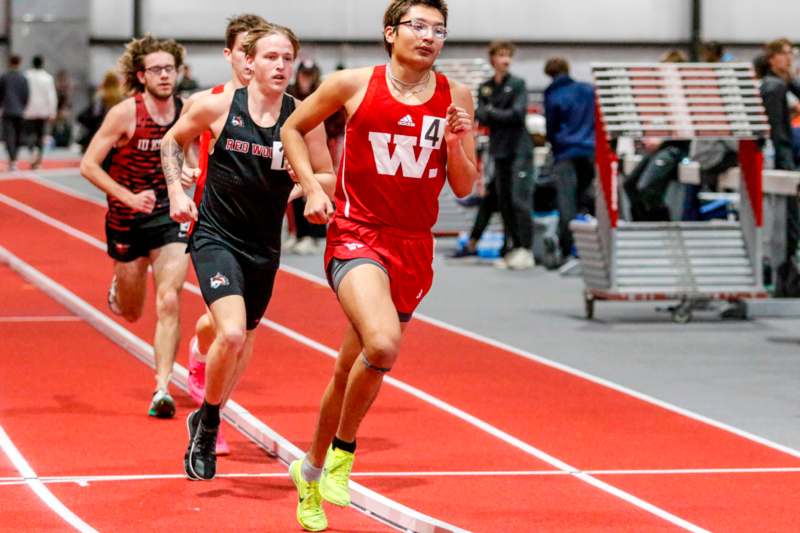 a group of people running on a track