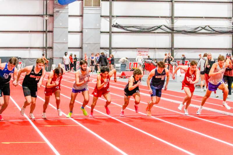 a group of people running on a track