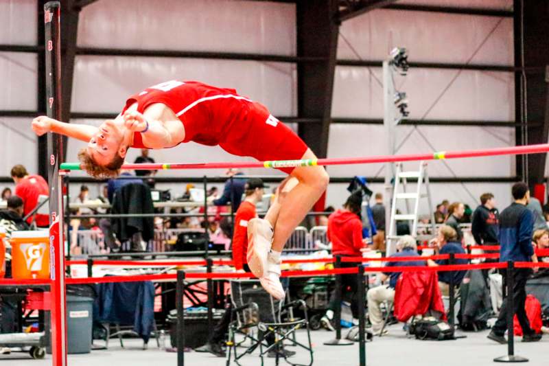 a man jumping over a bar