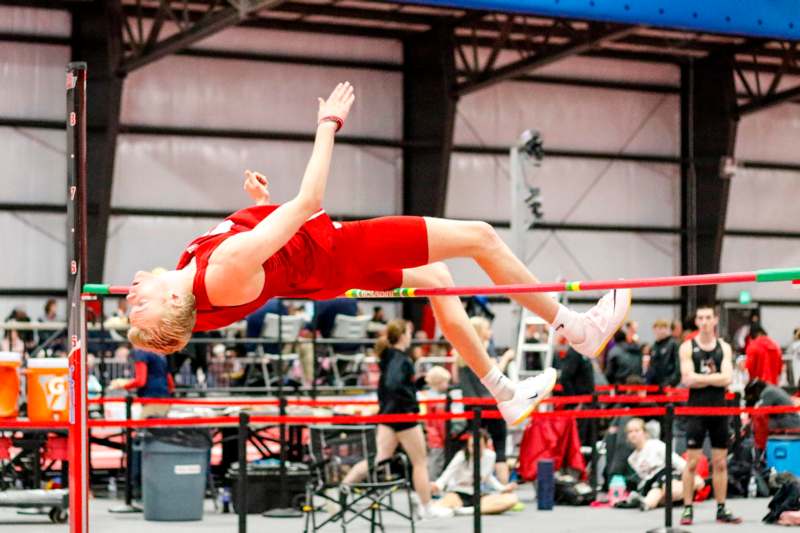 a man jumping over a bar