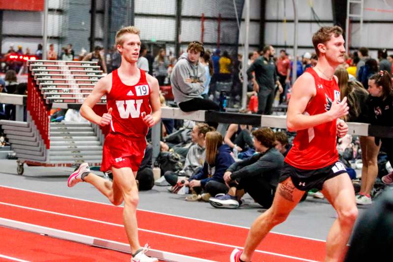 a group of men running on a track