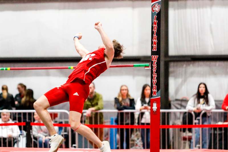 a man jumping over a pole